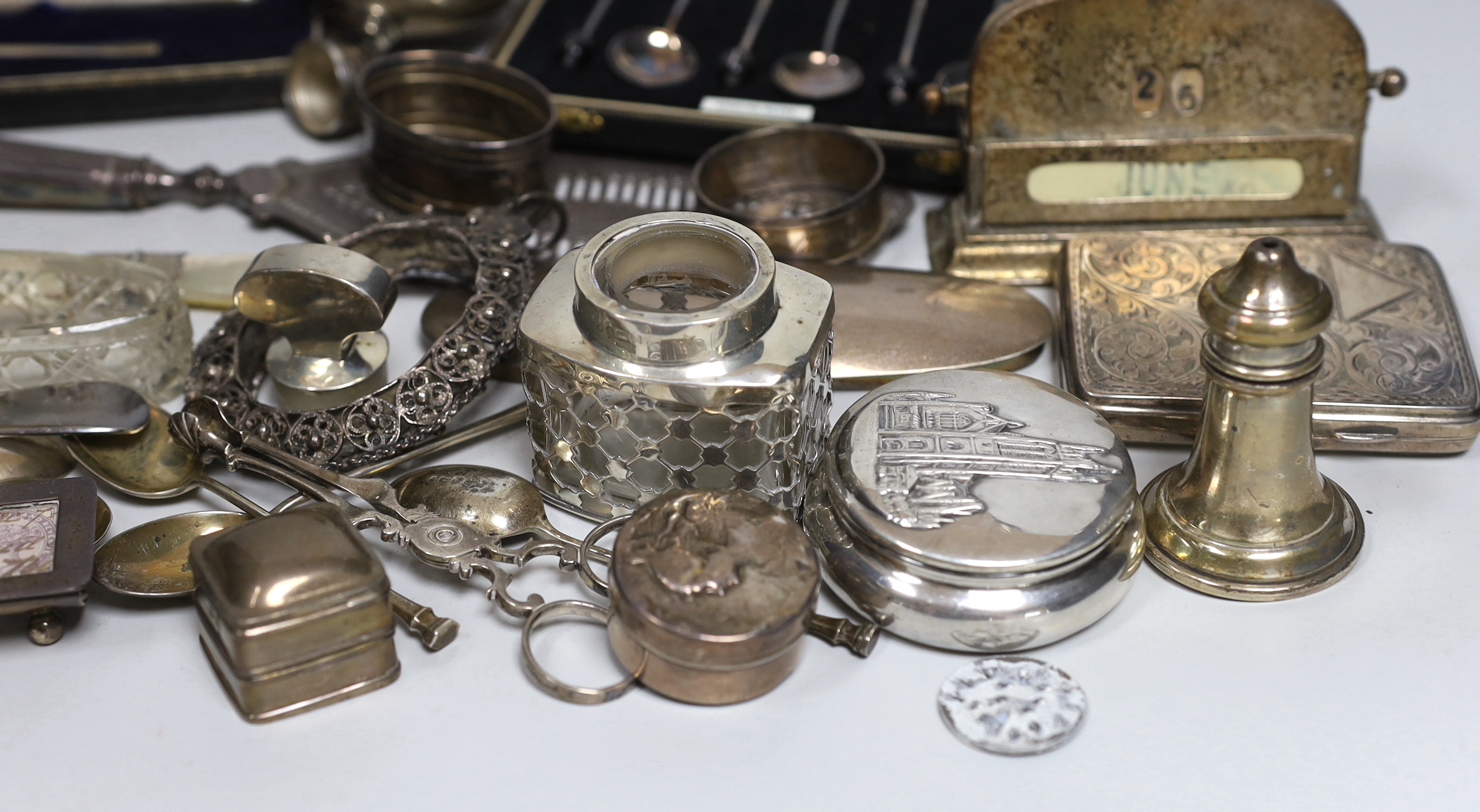 A group of assorted minor silver, including cased coffee spoons, christening trio, Georgian silver cream jug, cigarette case, trinket box, condiments, enamelled box, sugar nips, flatware, George III fish slice, London, 1